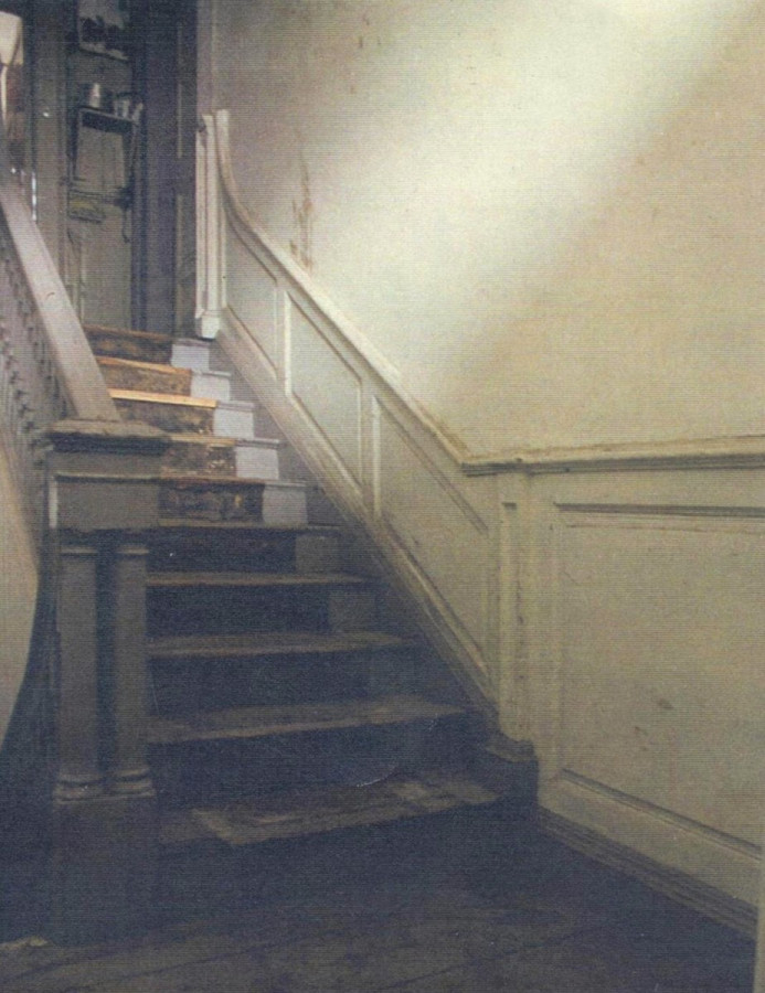 Elegant original staircase with double newels and wainscot panelling